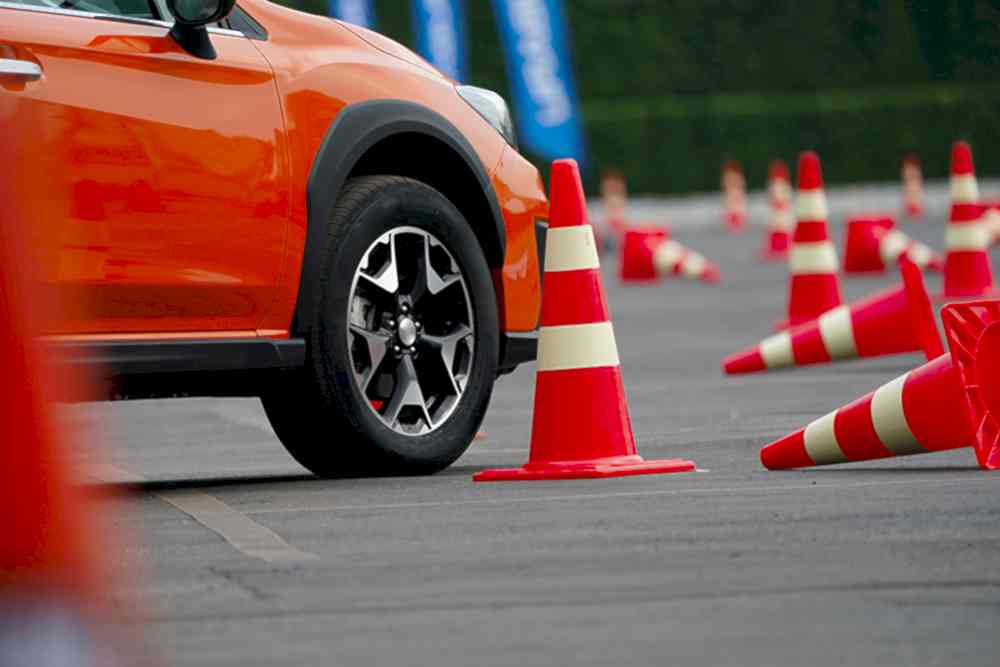 close up wheel of orange car on the road